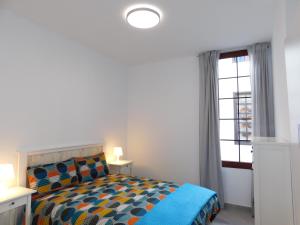 a bedroom with a bed and a window at LOLALAND in Morro del Jable