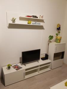 a living room with a television on a white entertainment center at Apartments REST - Bulevar in Novi Sad