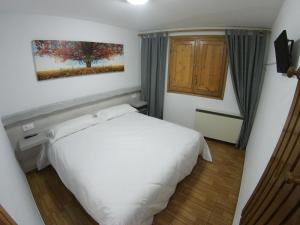 Posteľ alebo postele v izbe v ubytovaní Hostal Casa Palmira