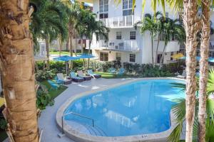 an overhead view of a swimming pool with palm trees at Coral Reef at Key Biscayne in Miami