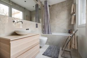 a bathroom with a sink and a toilet and a tub at Feel Home in Vienna in Vienna