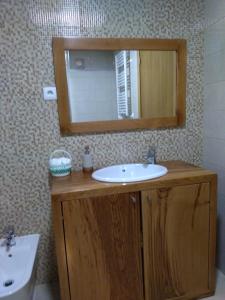 een badkamer met een wastafel en een spiegel bij Casa de Xisto Ti Lucília in Videmonte