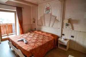 Postel nebo postele na pokoji v ubytování Hotel Cristallo