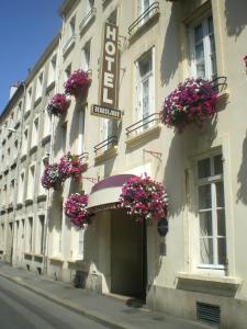 a building with flower baskets on the side of it at Cit'Hotel Hôtel Beauséjour in Cherbourg en Cotentin