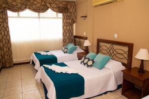 Ένα ή περισσότερα κρεβάτια σε δωμάτιο στο Resort y Parque Acuatico Valle Dorado