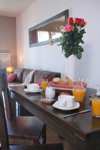 a table with food and a vase of flowers on it at Résidence Le Pic de l'Ours in Font-Romeu
