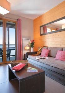 a living room with a couch and a table at Résidence Le Pic de l'Ours in Font-Romeu