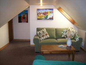 a living room filled with furniture and a couch at Highland Park House in Kirkwall