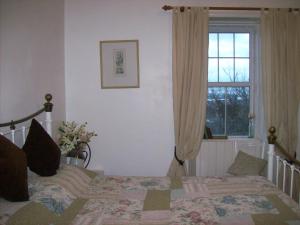 a bedroom with a bed and a window at Highland Park House in Kirkwall