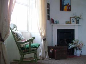 a living room with a chair and a window at Highland Park House in Kirkwall