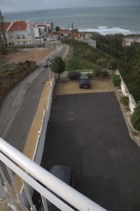 a car parked in a parking lot next to the ocean at Ericeira Sunset Apartment in Ericeira