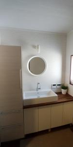 ein Badezimmer mit Waschbecken und Spiegel in der Unterkunft Hakuba Powder Cottage Crystal in Hakuba