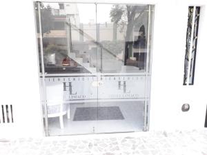 a glass door with a table and a chair in a room at Hotel Limaco in Neiva