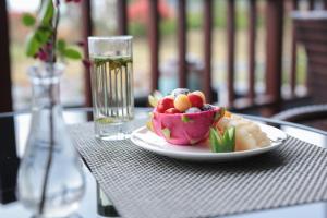 a plate of food on a table with a glass of water at SSAW Boutique Hotel Hangzhou Qiandao Lake in Chun'an