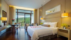 A bed or beds in a room at Dahongpao Resort