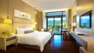 A bed or beds in a room at Dahongpao Resort