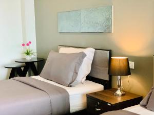 a bedroom with a bed and a table with a lamp at Tandeaw View in Hua Hin