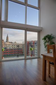 a room with a large window with a view of a city at CITY CENTRE APARTMENT with Free Secure Underground Parking in Glasgow