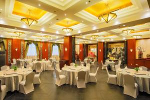 a banquet hall with white tables and white chairs at Anting Villa Hotel in Shanghai