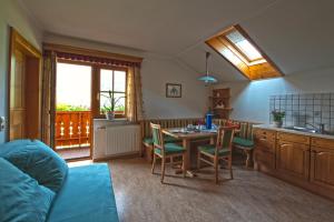 a kitchen with a table and chairs in a room at Hausebengut in Bad Gastein +21 photos