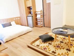 A bed or beds in a room at See U Tainan Apartment