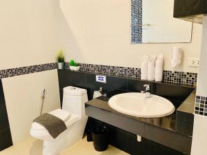 a bathroom with a toilet and a sink at Tandeaw View in Hua Hin