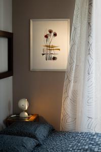 a bedroom with a bed with a white curtain at MaMà Suite in Lecce