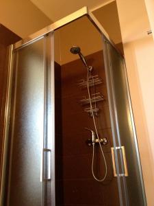 a shower with a shower head in a bathroom at MaMà Suite in Lecce