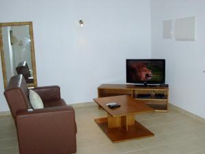 sala de estar con TV, sofá y mesa de centro en RC - Pata Residence, en Albufeira