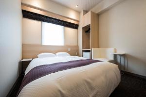 Nagasaki Bus Terminal Hotel客房内的一张或多张床位