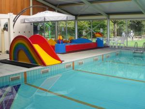 a large swimming pool with a playground and a slide at Vakantieoord De Bronzen Emmer in Meppen +30 photos