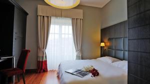 Postel nebo postele na pokoji v ubytování Hotel Porta Felice & Spa