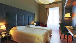 Postel nebo postele na pokoji v ubytování Hotel Porta Felice & Spa