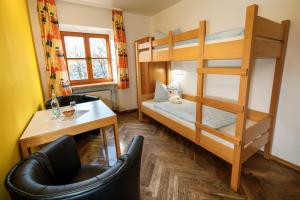 a small room with a bunk bed and a desk at Jugendherberge Regensburg in Regensburg