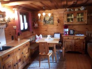 a kitchen with a table in a log cabin at Ferienhaus "Badl" in Bad Goisern