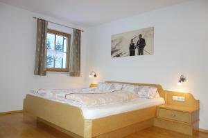 Schlafzimmer mit einem Bett und einem Fenster in der Unterkunft Ferienwohnung Brugger in Sankt Gallenkirch