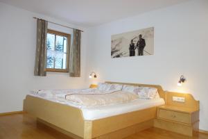 a bedroom with a bed and a window at Ferienwohnung Brugger in Sankt Gallenkirch