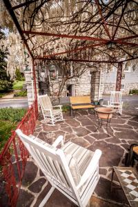 a white rocking chair sitting on a stone patio at Friendly City Inn B&B in Harrisonburg
