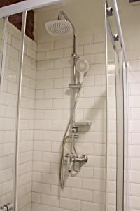 a shower with a shower head in a bathroom at Maria's homestay in Tbilisi City