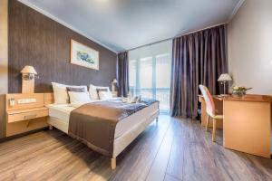 Posteľ alebo postele v izbe v ubytovaní MenDan Magic Spa & Wellness Hotel