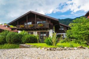 a house with a balcony on top of it at Haus im Winkl in Bad Hindelang