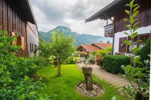 a garden with a fire hydrant in the middle of a yard at Haus im Winkl in Bad Hindelang +3 photos