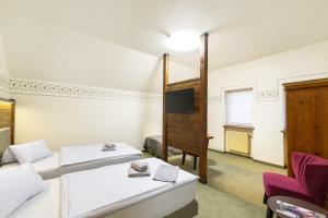 Voodi või voodid majutusasutuse Hotel U Simla toas