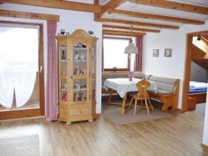 a living room with a table and a room with a bedroom at Haus Bayrhof in Hopferau