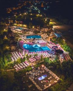 an aerial view of a swimming pool at night at The Wind Mills Hydropark in Gorna Malina