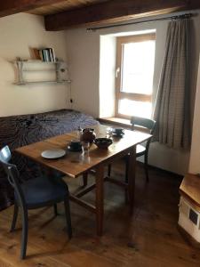 a room with a table and chairs and a bed at Rustico Cadrobi 20 in San Vittore