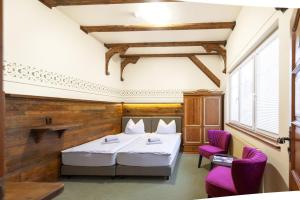 Voodi või voodid majutusasutuse Hotel U Simla toas