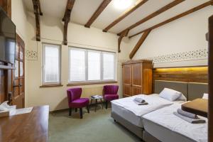 Voodi või voodid majutusasutuse Hotel U Simla toas