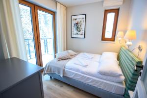 Posteľ alebo postele v izbe v ubytovaní Apartamenty Sun & Snow Bukowa Dolina