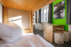een slaapkamer met een bed en een groene muur bij Jugendherberge Burghausen in Burghausen